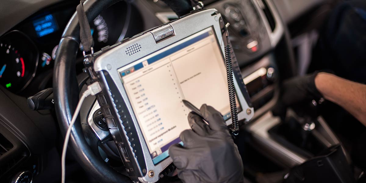 mechanic using car diagnostics screen